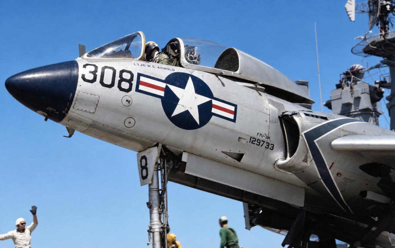 A US Navy Vought F7U-3M Cutlass on a carrier deck in the mid-1950s, its fuselage carrying a national insignia roundel, the side number 308 and stencilled service markings