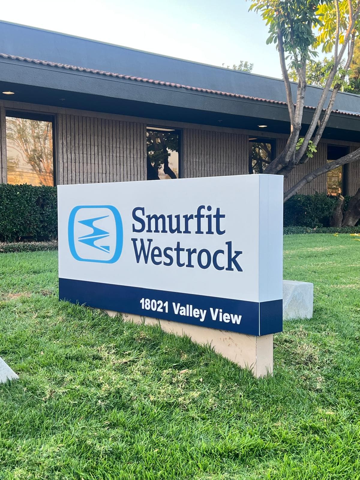 Front elevation of the Smurfit Westrock monument sign on a lawn in front of an office building