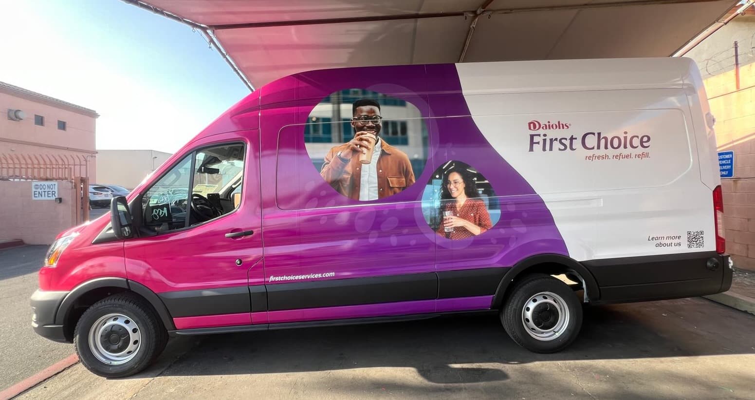 Ford Transit high-roof van wrapped in a magenta to purple gradient with photographs of two people holding drinks and the Daiohs First Choice logo on a white rear panel