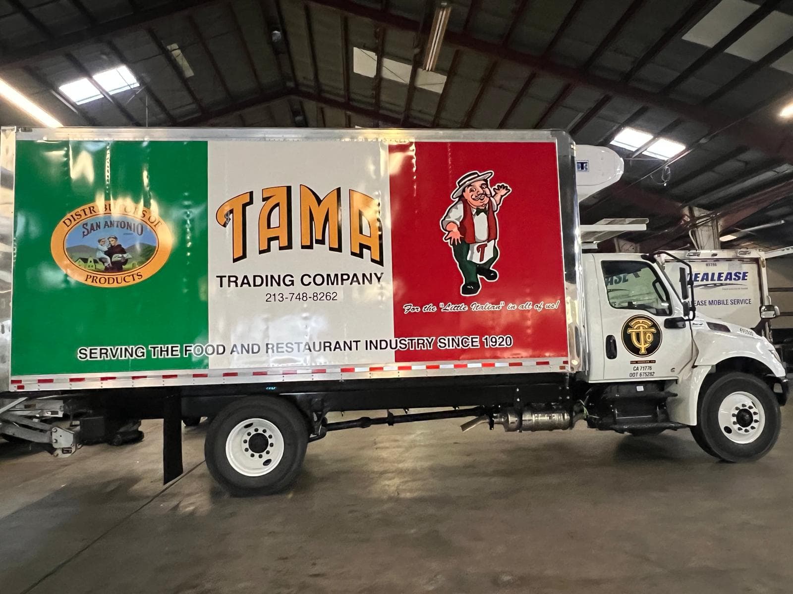 Second Tama Trading Company delivery truck with matching panel graphics